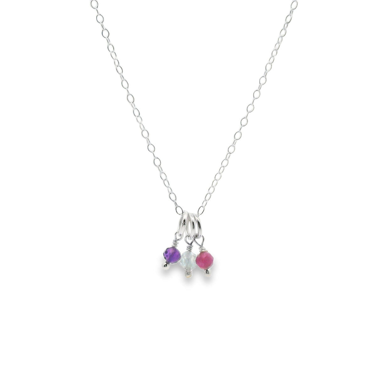 Necklace with three small colored beads on a white background