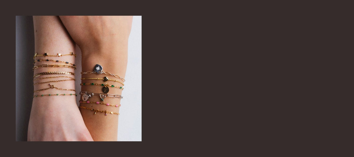 Stacked welded bracelets on two wrists