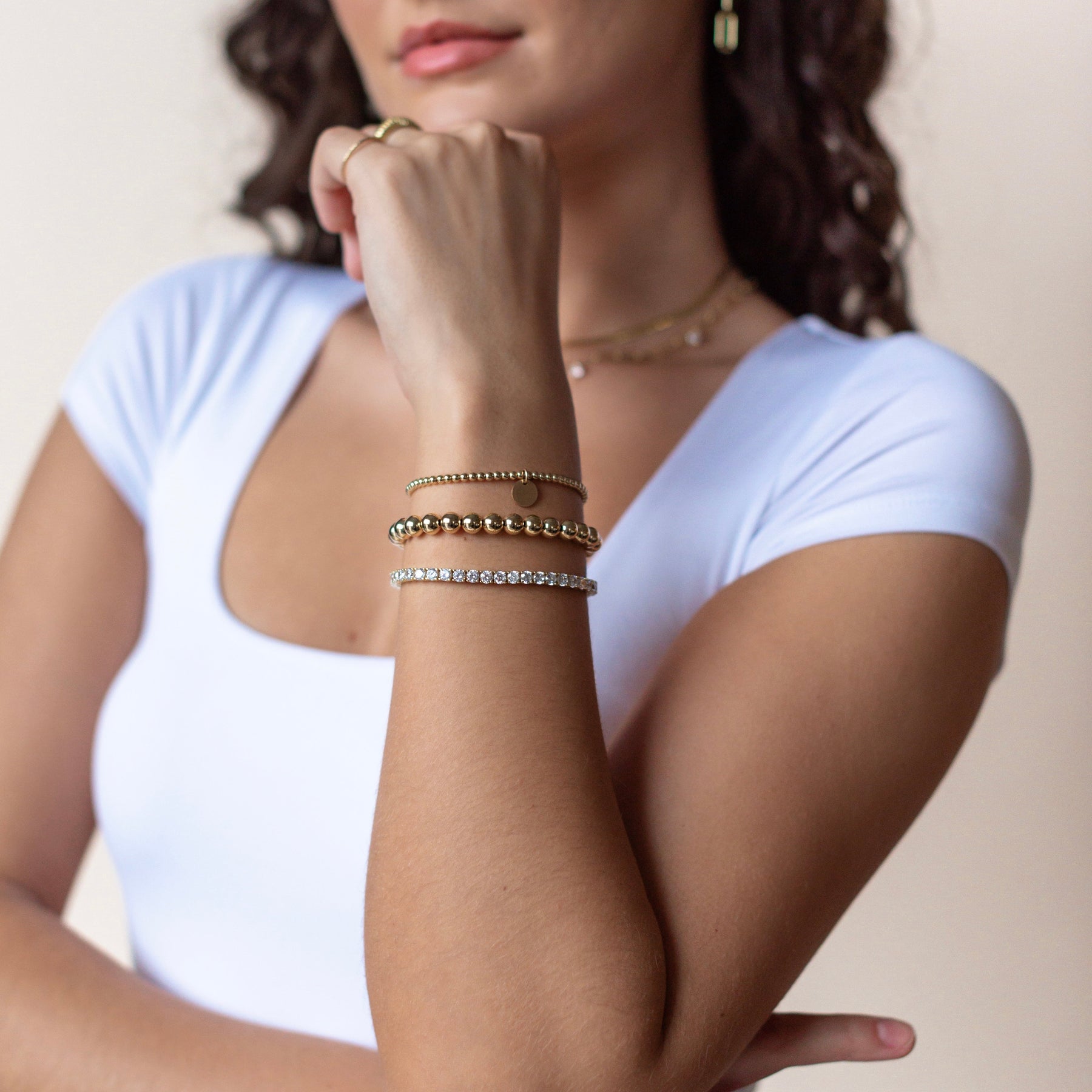 layered old filled ball bracelets and tennis bracelet