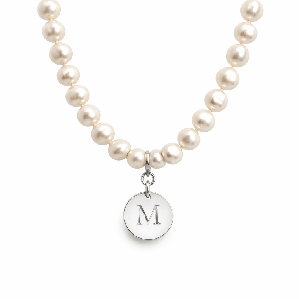 Pearl necklace with a silver pendant featuring the letter 'M' on a white background