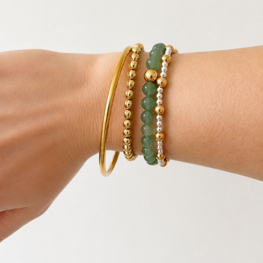 classic thin gold bangle stacked with ball bracelets
